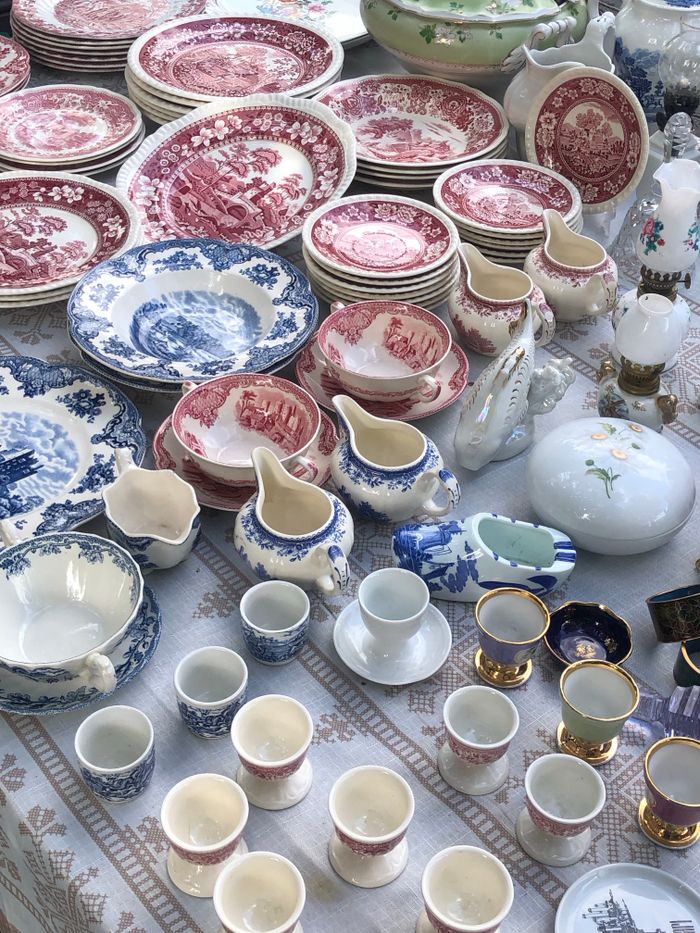 Services An assortment of antique porcelain plates and cups in various colors and patterns on display.